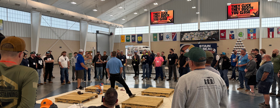 Contractors watching live fence staining and sealing demonstration during Stain and Seal University event