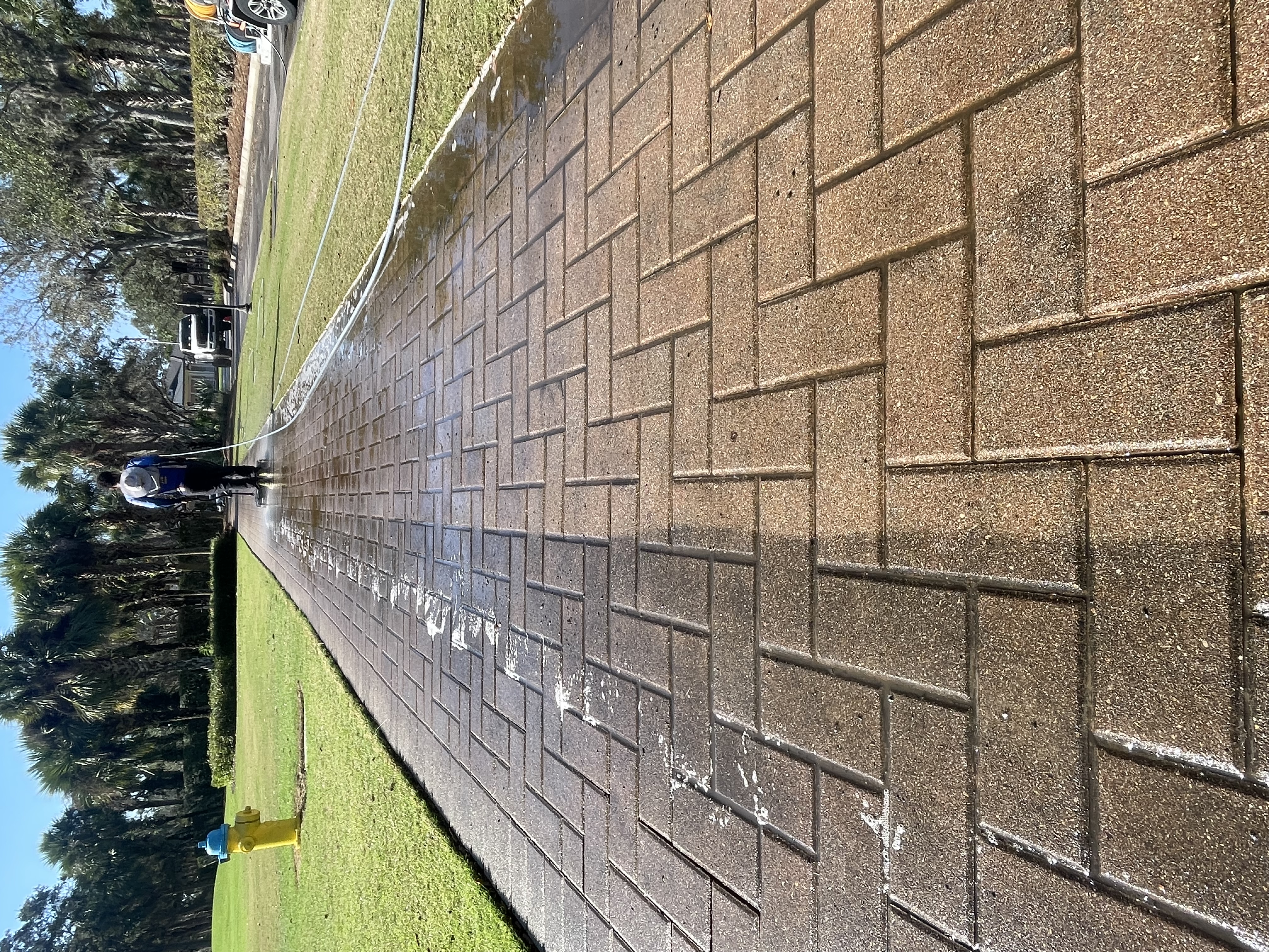 Professional pressure washing of a residential concrete driveway by Patrick's Pressure Washing, improving curb appeal and removing dirt and stains.