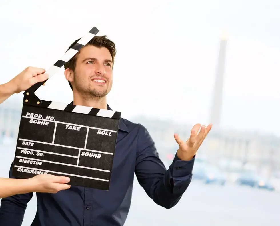 Smiling man with a film clapperboard, symbolizing leaders acting or performing instead of showing authentic behavior.