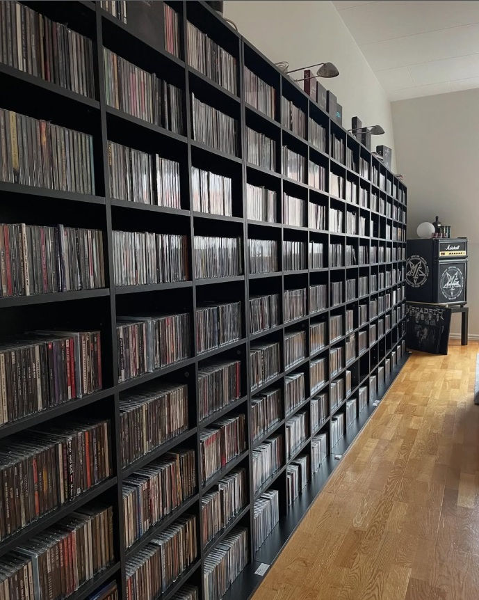 A library of CD cases and a Marshall Cabinet fridge