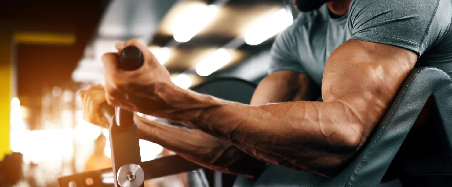 strong-man-doing-biceps-exercise-at-the-gym.webp
