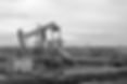 black and white photo of oil derrick wit
