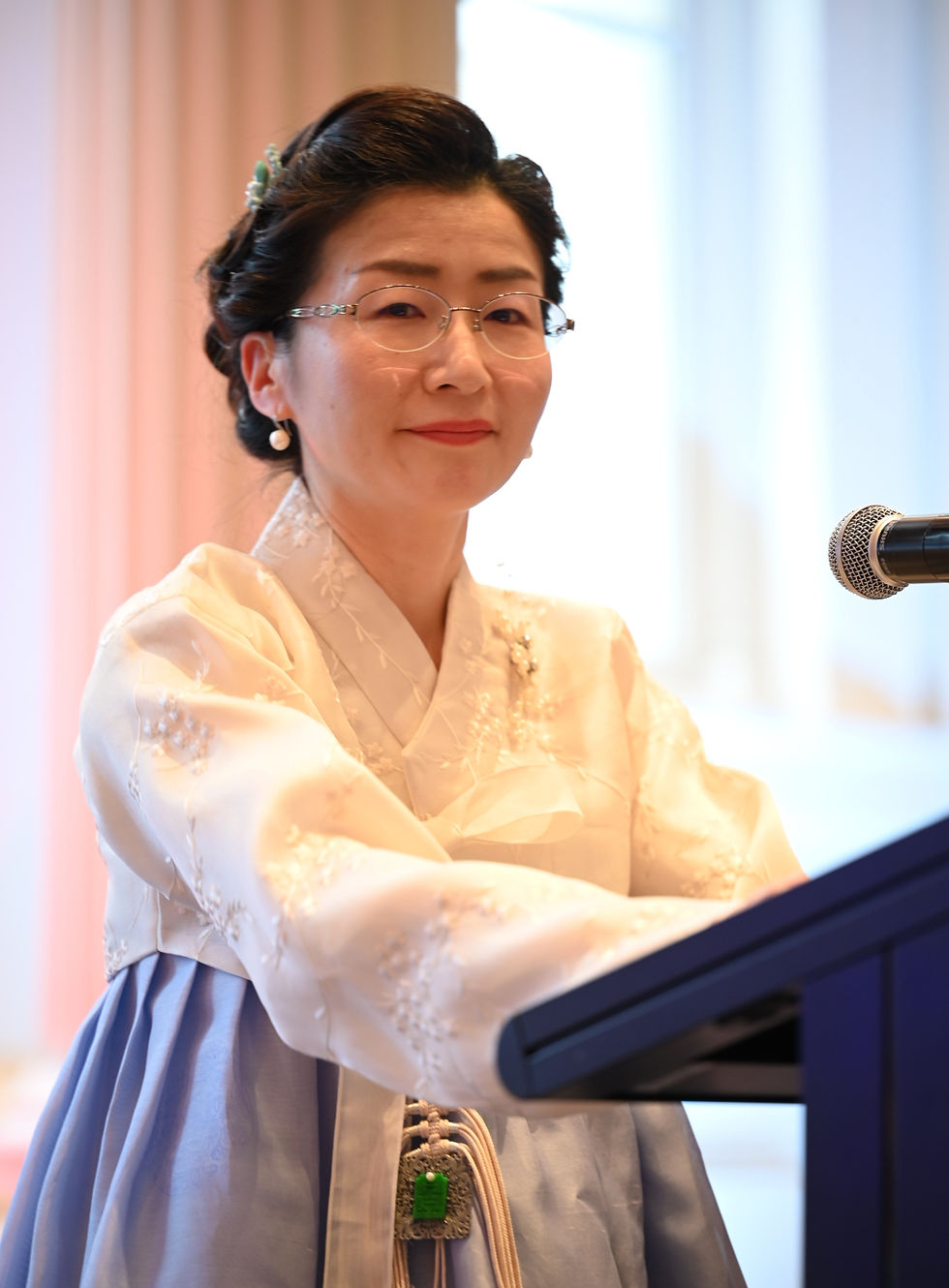 Founder of Hanbok Australia presenting a hanbok fashion show at Gunbae cultural event in Melbourne