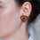 Thumbnail: Model wearing the Explorer - Handmade Glass Bead Star Earrings in orange
