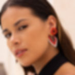 Model wearing the Explorer - Handmade Glass Bead Star Earrings in red