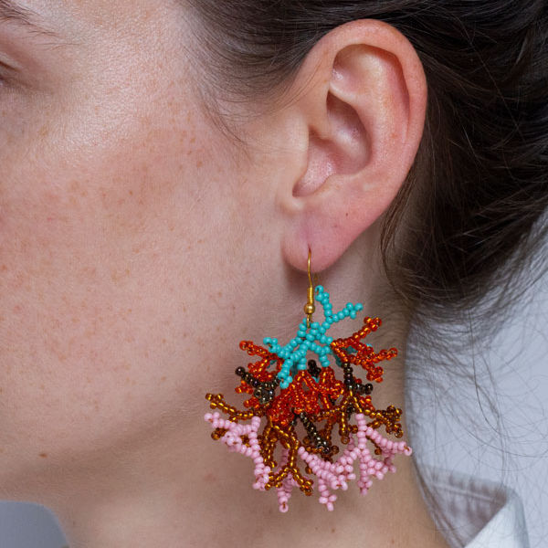 Model wearing The Wanderer – Unique Handmade Statement Earrings in orange mint