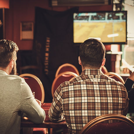 Cheerful old friends watching sports and