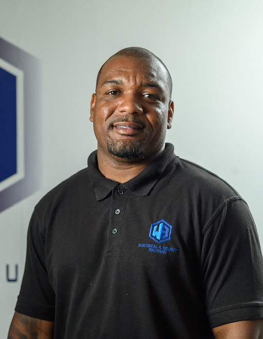 Jerome James smiling beside WB Electrical & Security Solutions logo, Connected. Stay Protected.