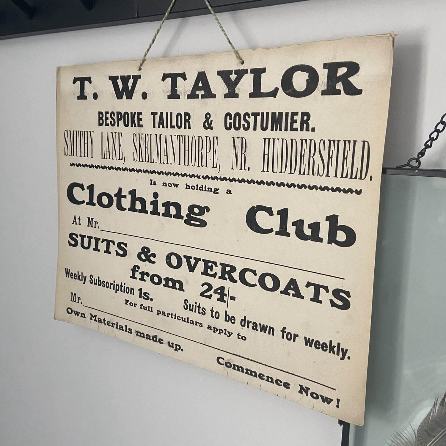 A Vintage Cardboard Shop Advertising Sign