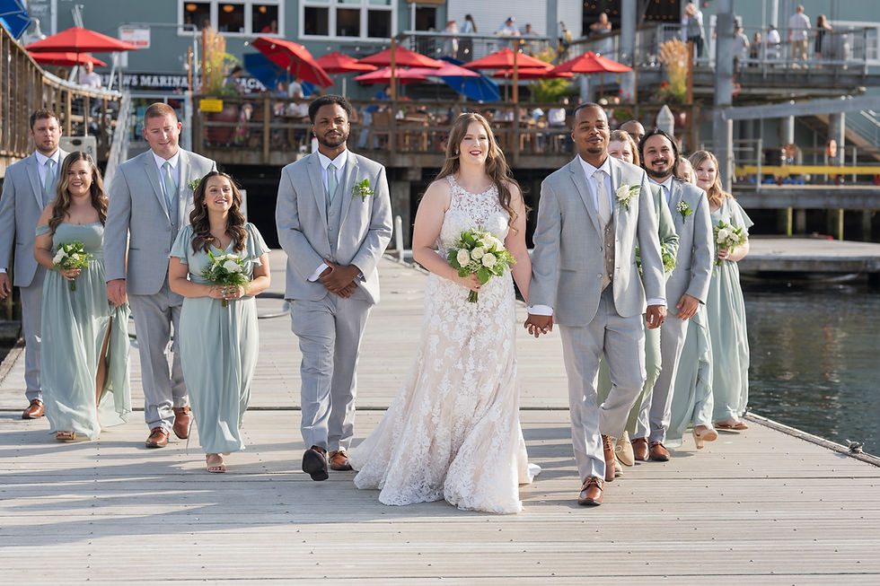 Wedding party walks on dock at Waterfront Venue at the Narrows Marina for wedding by Sage and Soul Tacoma