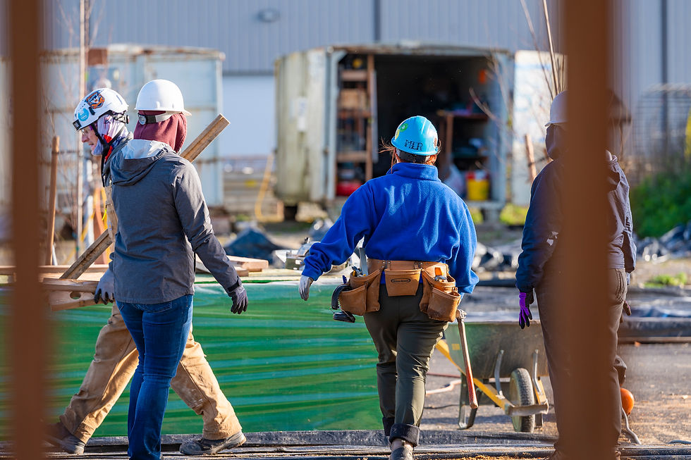 Women volunteers walk together at Habitat for Humanity Women Day build on site with marketing photography from Sage + Soul