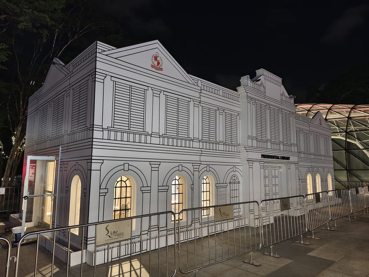 Illuminated white classical building facade at night