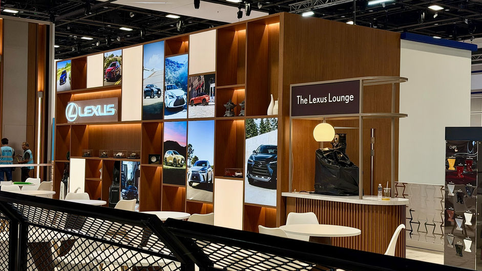 Lexus exhibition booth with 'The Lexus Lounge' sign and car displays