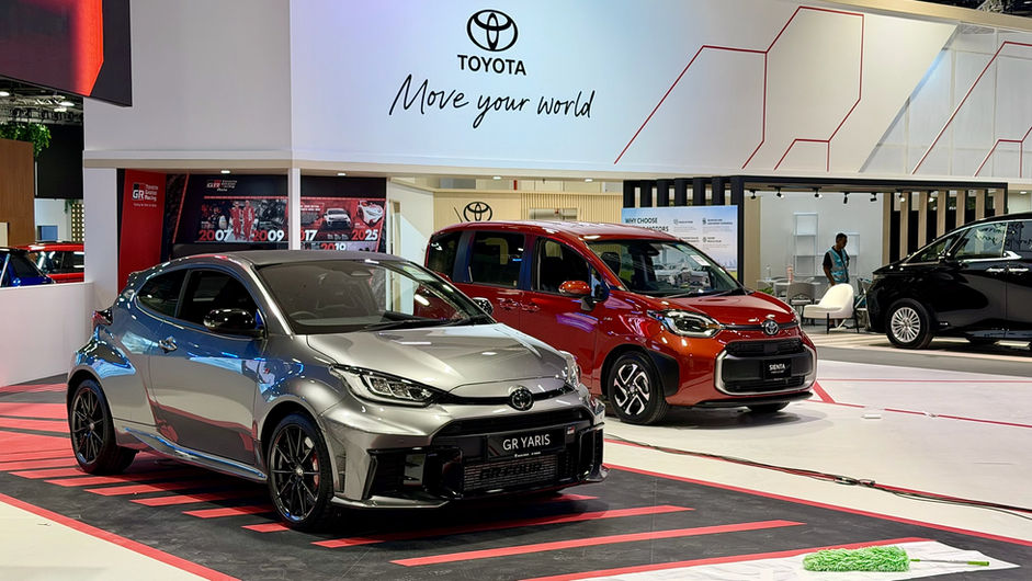Toyota GR Yaris and red car at an auto exhibition