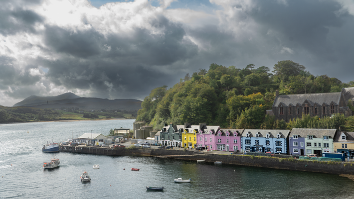 Colorful houses line the harbor in Portree, Isle of Skye.