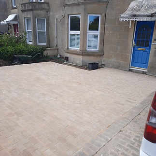A block-paved driveway next to a house