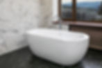 luxury-apartment-bathroom-with-standalone-ceramic-bath-marble-walls-panoramic-window-with-