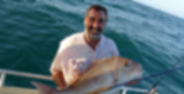 IGFA Capt. Allan Bevan hold a ripper pink snapper caught on fly.