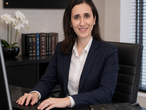 Evi Papacleovoulou seated at her desk beside Cyprus law reports