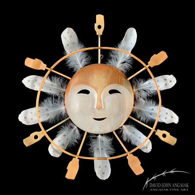 Currently Available: Yupik Story Mask called Peace Within. Reminiscent of traditional moon masks, this work mask depicts a smiling face with feathers, one hoop, and hand appendages attached around its perimeter. The face of the mask is two toned white and red ochre.
