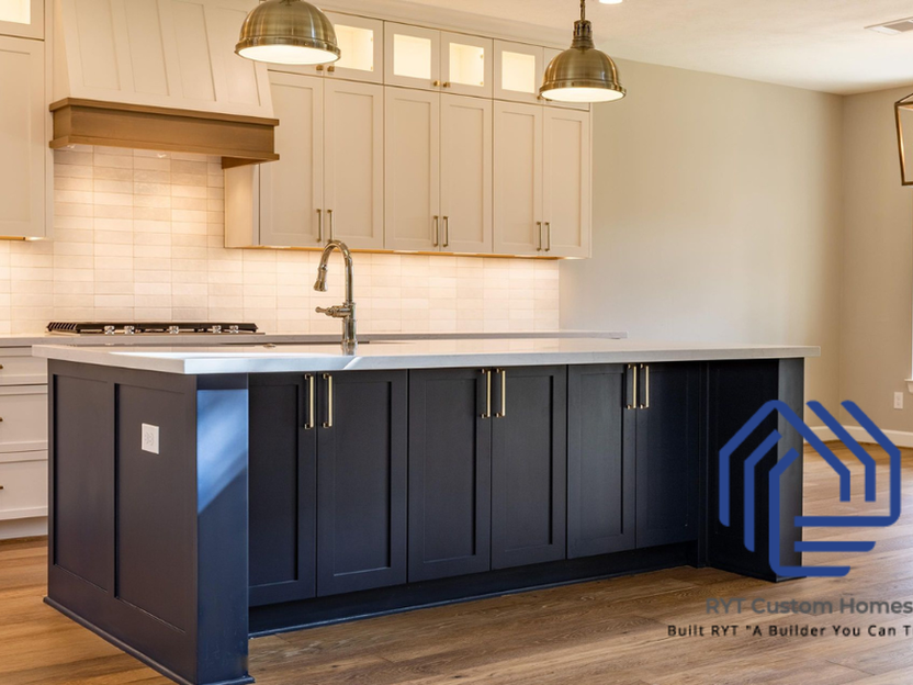 Kitchen island with dark cabinets, and white stone counter top.