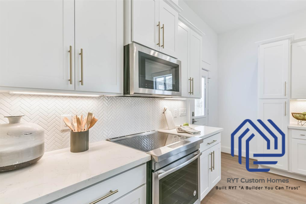 white kitchen cabinets, countertops, smooth range and microwave. 