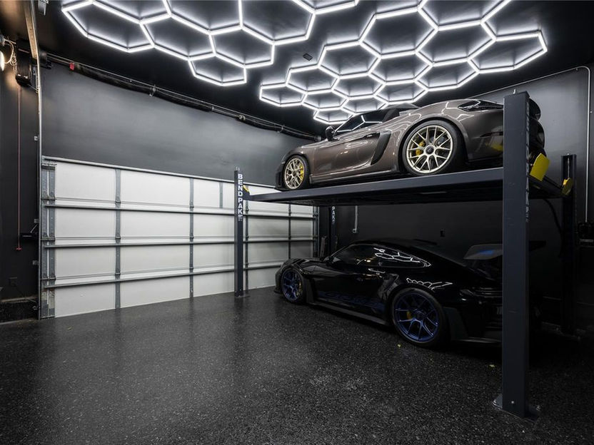 Unique garage with auto lift to store two vehicles in one space.  