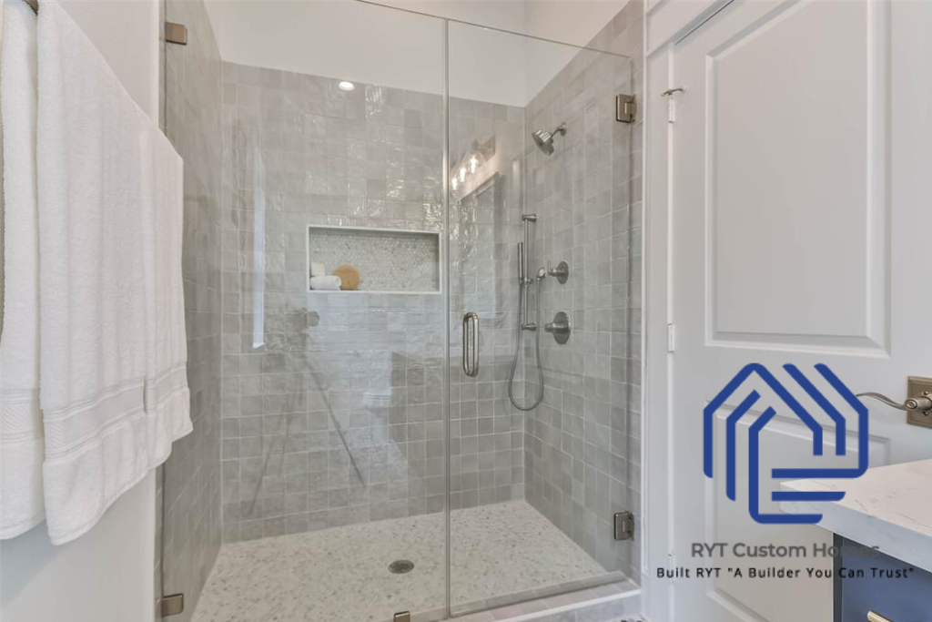 beautiful walkin shower with glass doors and tiled wall and shower pan. 