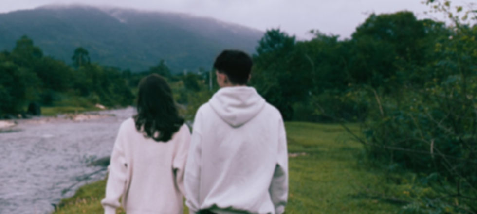 Couple walking by river after couples therapy