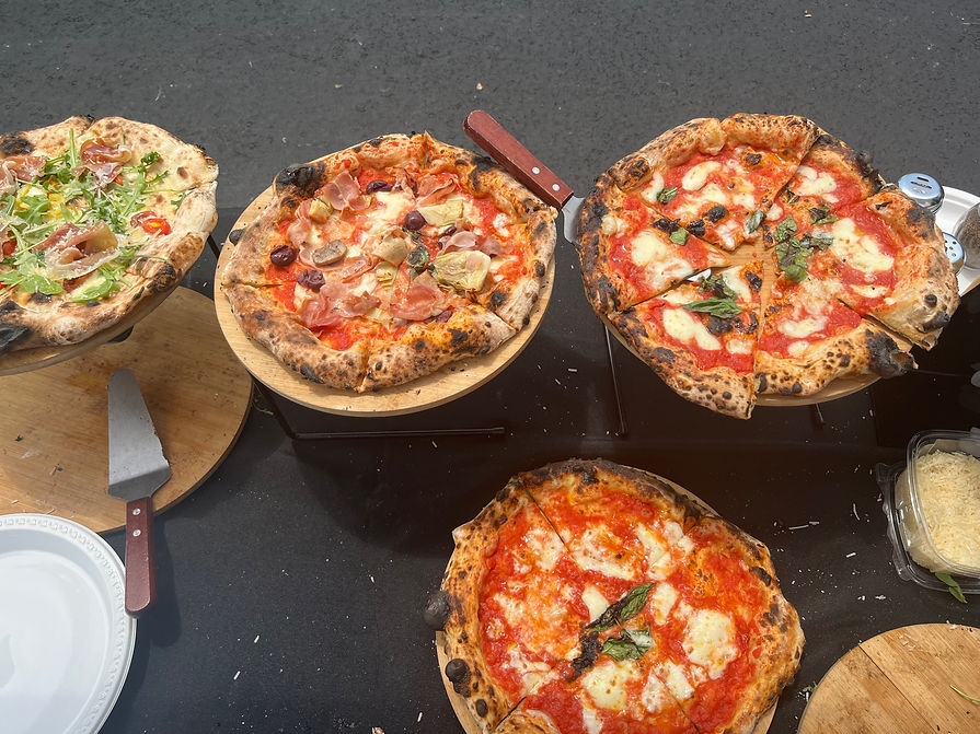 Four wood-fired Neapolitan pizzas with diverse toppings ready to serve at Culto Italiano Bergen County NJ