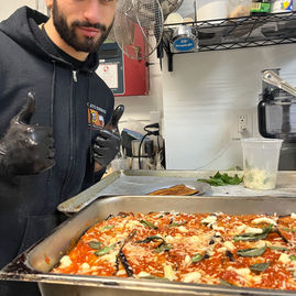 chef riccio showing off italian dish
