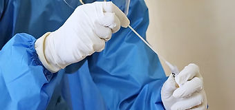 a laboratory worker takes a swab test_ed_edited.jpg
