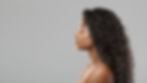 Hair extension concept. Profile portrait of beautiful curly african american woman over gr