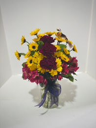 A medium arrangement with carnations and daisies.
