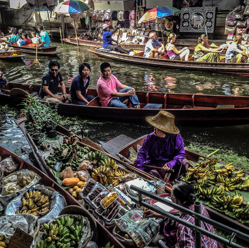 Floating market near Bangkok with traditional wooden boats