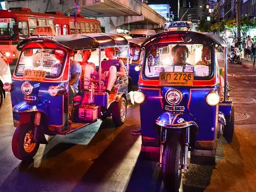 Traditional tuk tuk driving through the streets of Bangkok