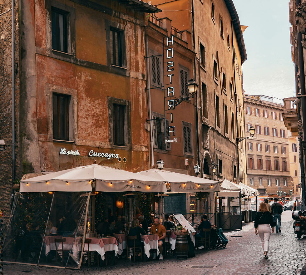 Cobblestone street in the Monti neighborhood with a restaurant and historic buildings