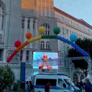 Berlin streets during Pride with rainbow flags and crowds celebrating