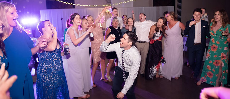 A group on the dancefloor singing and dancing at Kentucky wedding by RipTide Productions.