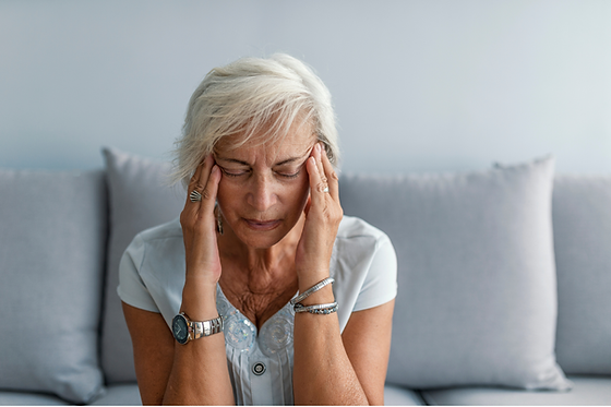 A women with a headache looking for chiropractic care