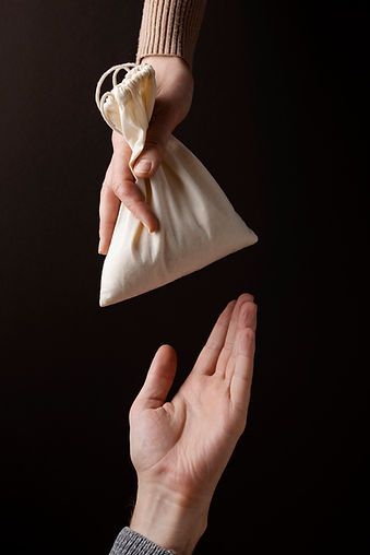 hand-giving-bag-with-grains.jpg