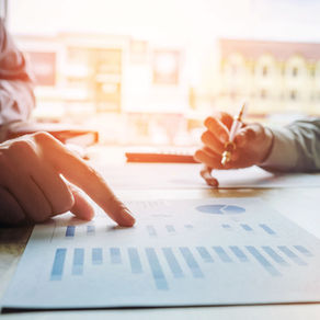 Two people reviewing marketing budget to remove waste