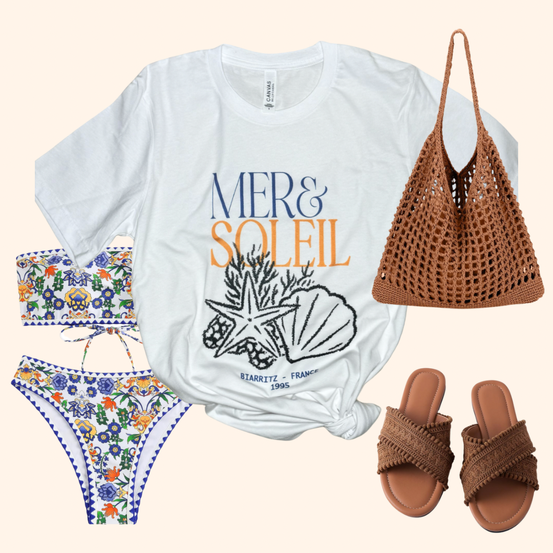 Sea and Sun Tee styled with a printed bikini, woven beach bag, and braided sandals for a resort-ready outfit flat lay.