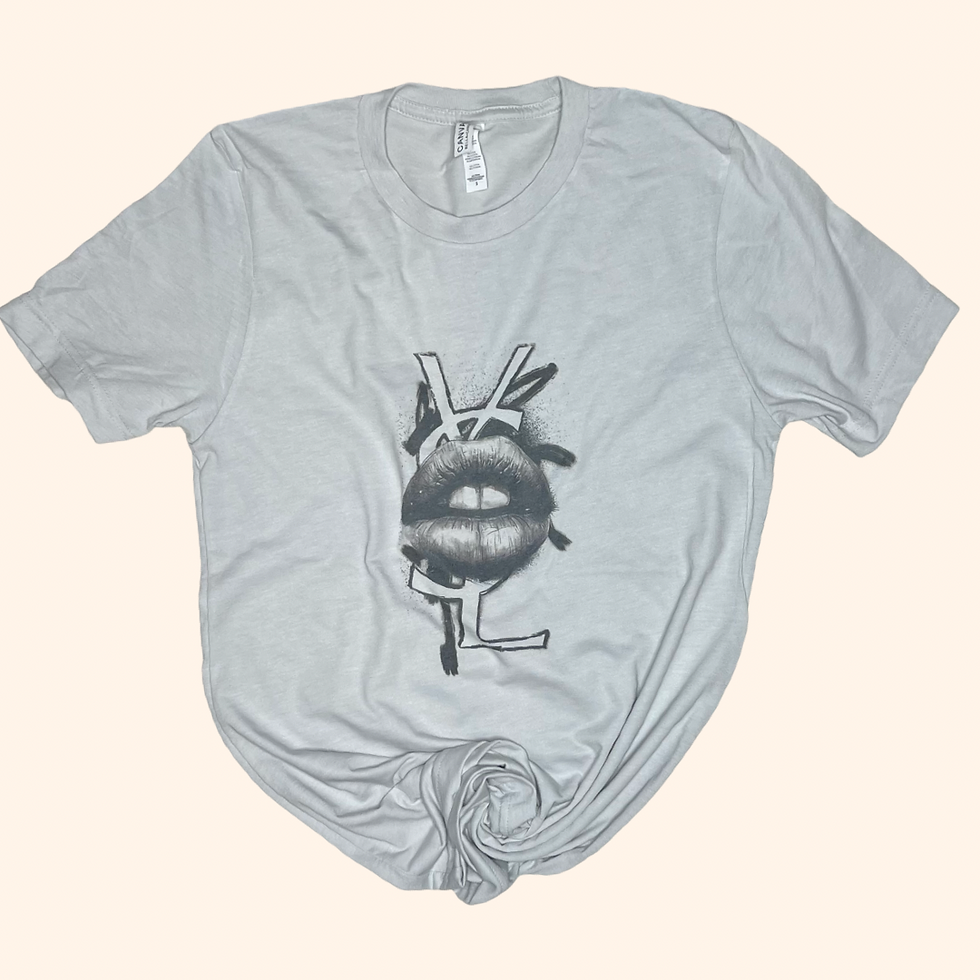 'Say More' graphic tee featuring a bold lip graphic and abstract elements, displayed flat on a light background