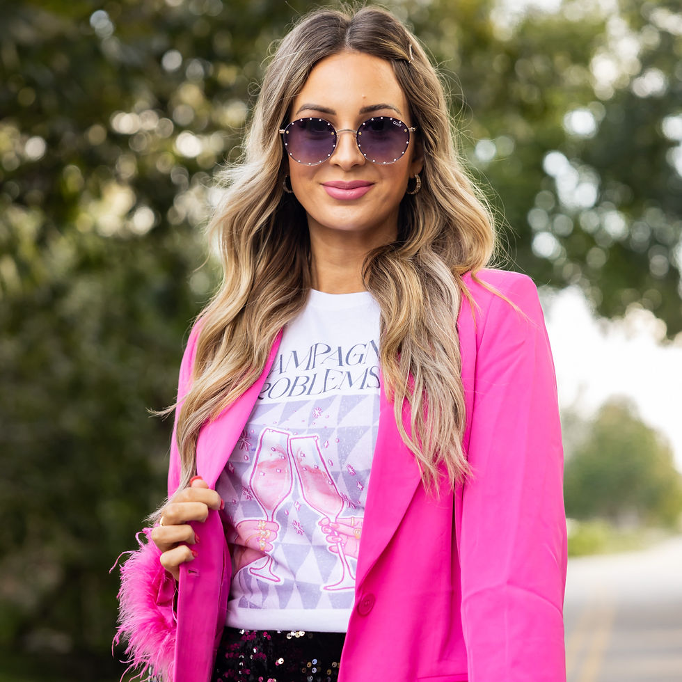 Thumbnail: Model wearing Champagne Problems shirt with hot pink blazer and sequin mini skirt for a bold going-out look.