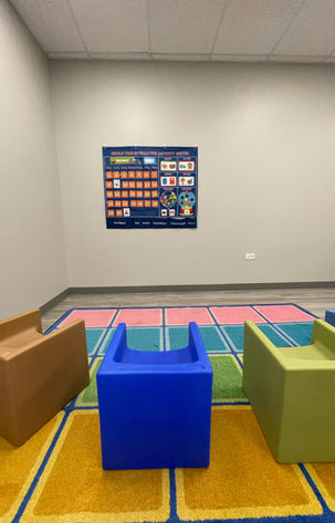 social skills group circle time room at an autism therapy center. bean bags, toys, learning environment, colorful, reading