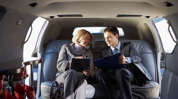 Business man and woman in limo.jpg