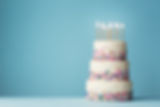 Birthday cake with three tiers and colorful sprinkles.jpg