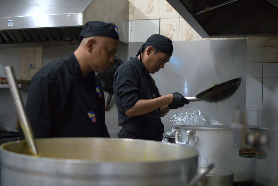Two chefs cooking in a kitchen