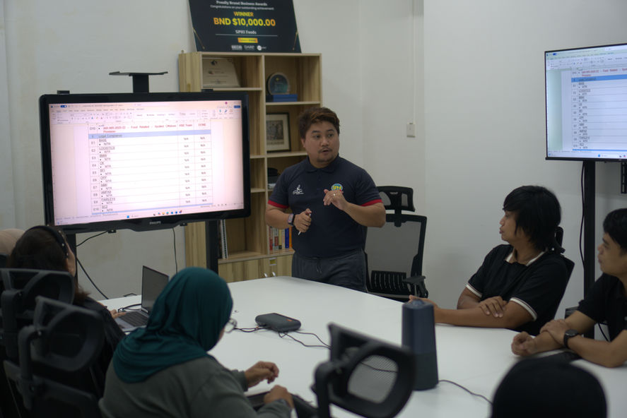 A meeting room with a man presenting his findings